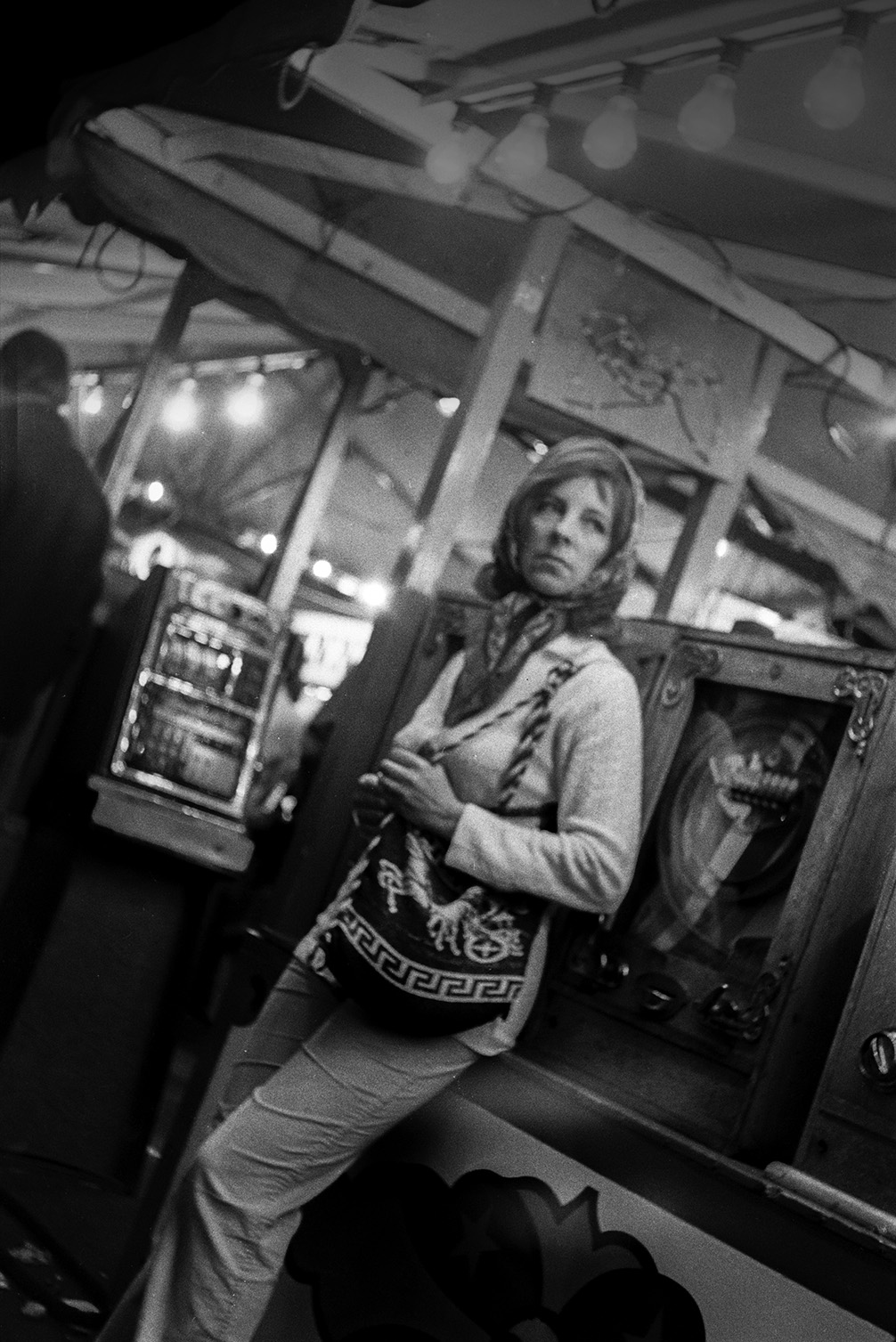 A woman standing by slot machines at Bideford Fair.