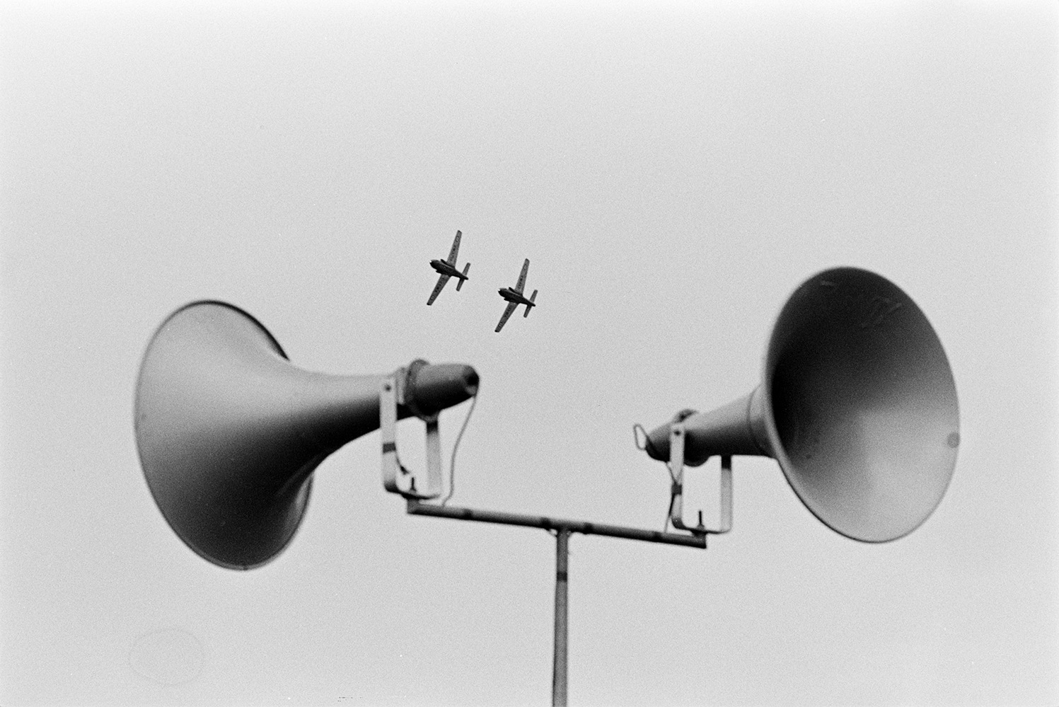 Loud speakers at Chivenor Air Show at the Royal Marine Base in Braunton. Two aeroplanes can be seen giving a display in the background.
