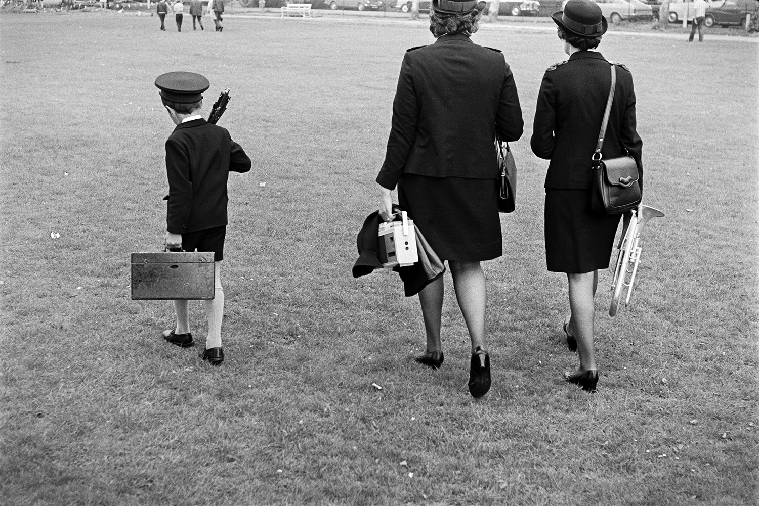 Two women and a boy from a band walking across the Rock Park, Barnstaple, carrying their instruments, possibly after the raft race.