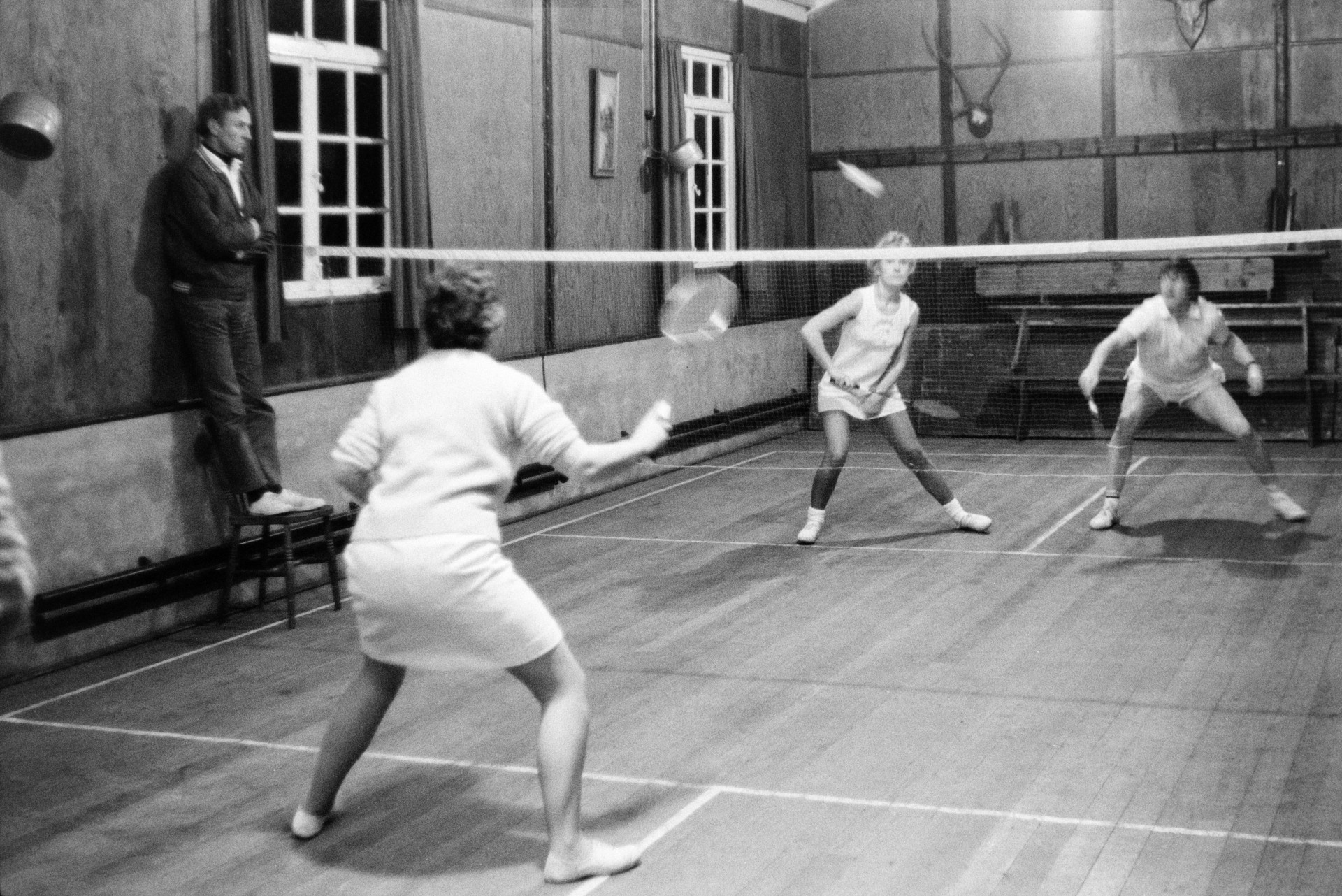 Women playing badminton in a village hall. It is possibly a match between Bideford and Hatherleigh.