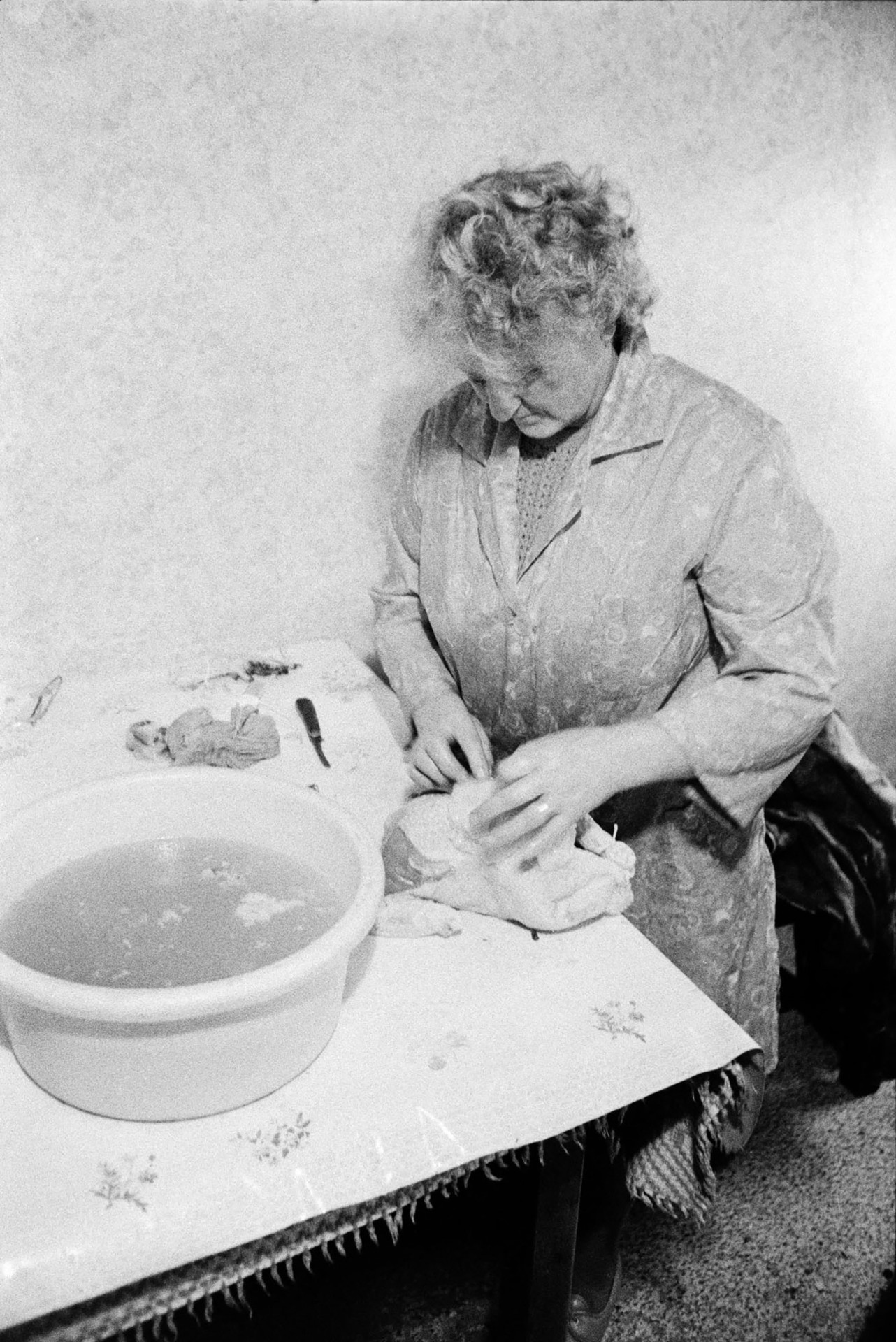 A woman preparing Christmas chickens in the kitchen at Mill Road Farm, Beaford. The farm was also known as Jeffrys.