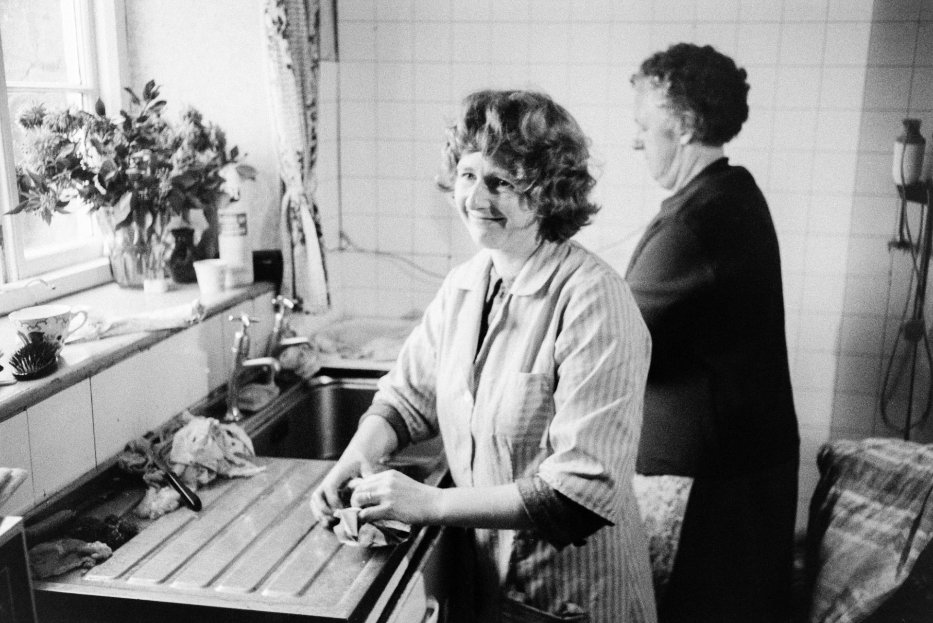 Marylin Bourne and another woman cleaning the sink in the kitchen at Mill Road Farm, Beaford after preparing Christmas chickens. The farm was also known as Jeffrys.