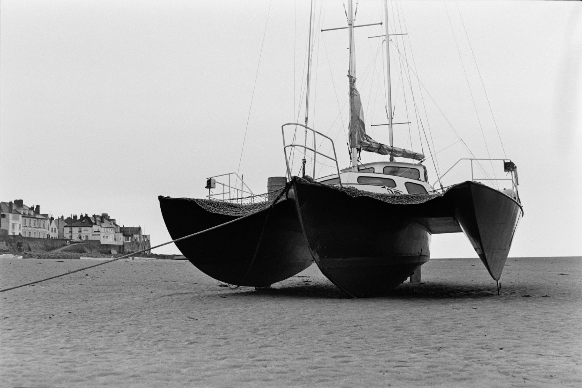 A trimaran or three hulled boat moored on the beach at Appledore.