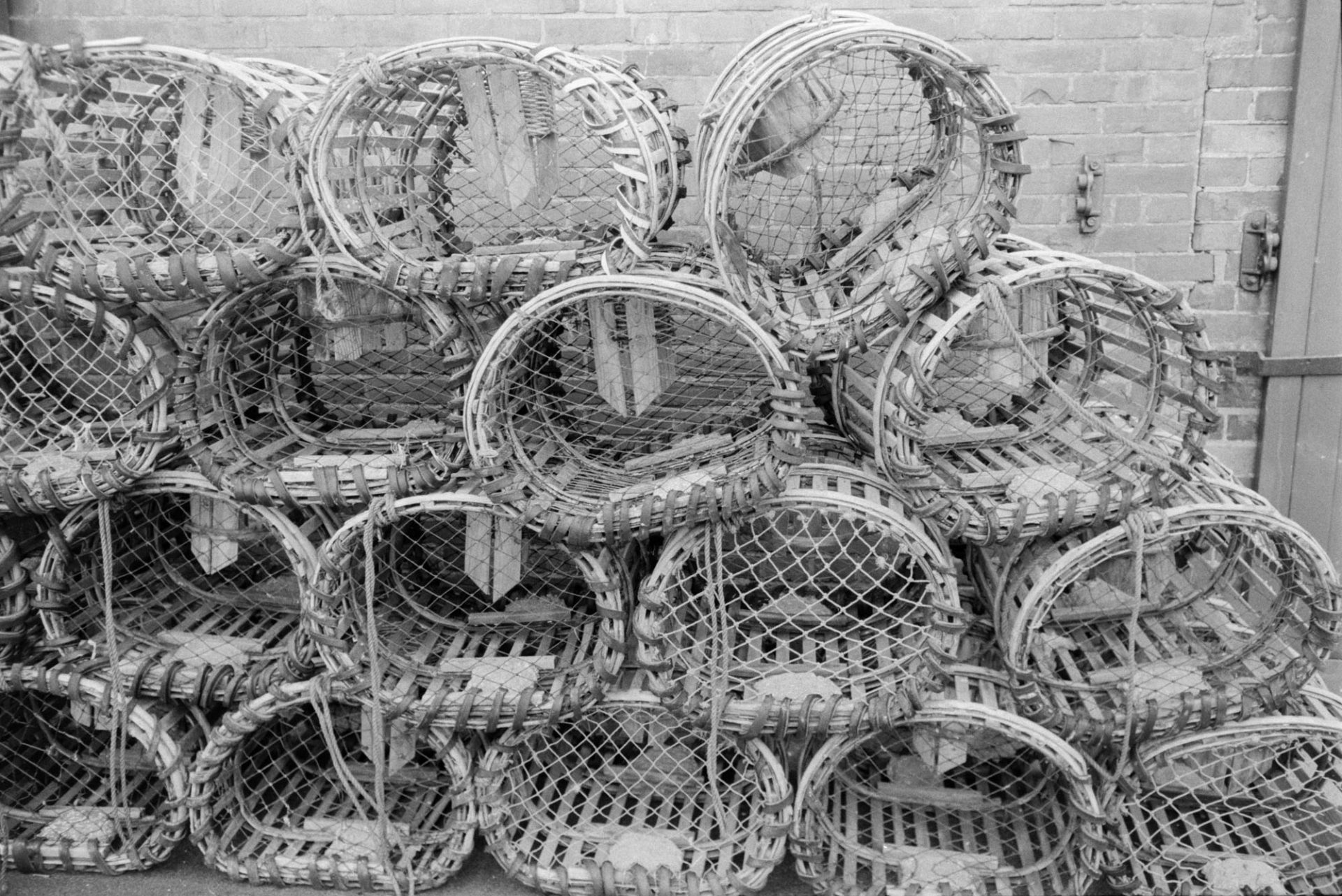 Lobster pots stacked against a wall at Ilfracombe.