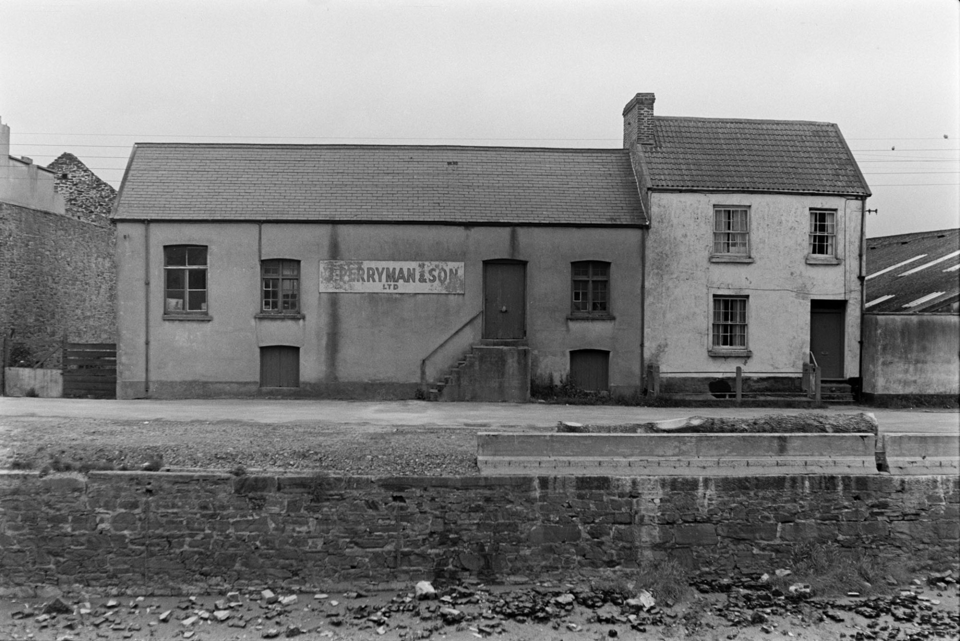 The premises of 'J Perryman & Son' on the banks of the River Taw at Barnstaple. It is possibly a warehouse of some kind.