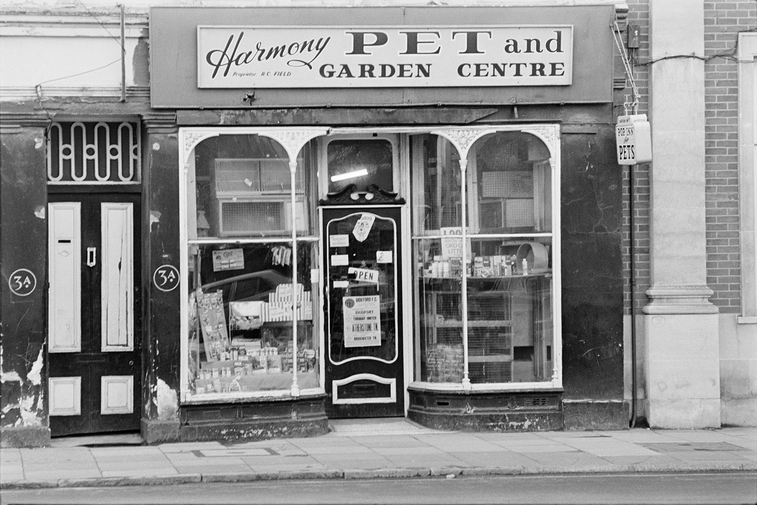 Harmony Pet and Garden Centre shop front, in Barnstaple. Various cages and pet toys are on display in the window.