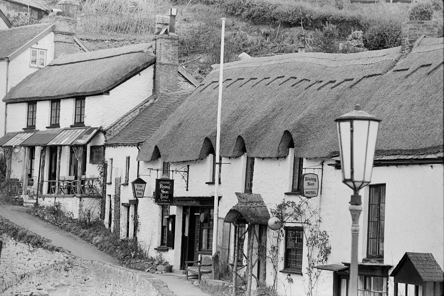 A row of thatched cottages and the Rising Sun Hotel, in Lynmouth.