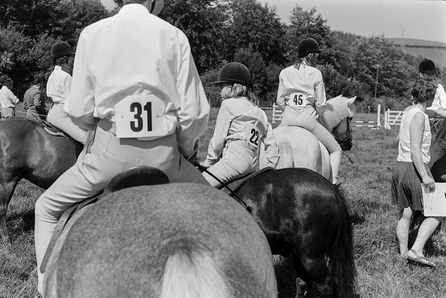 Mounted horse riders, including children, getting ready to compete in an event at the Wear Giffard gymkhana.