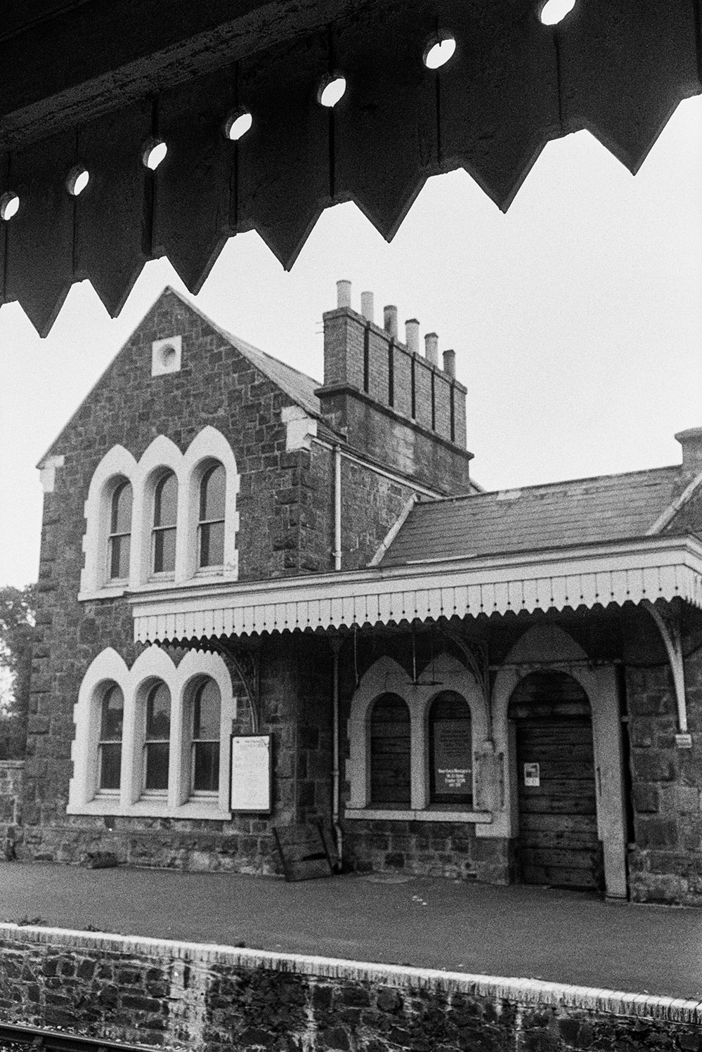 The main station building with arched windows at Bow Railway Station. The image is taken from the opposite platform.