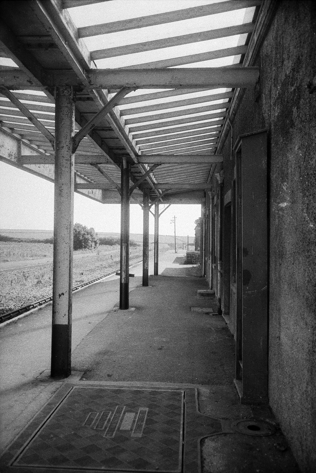 The platform at Woolacombe and Mortehoe Railway Station. A shelter extends over the platform.