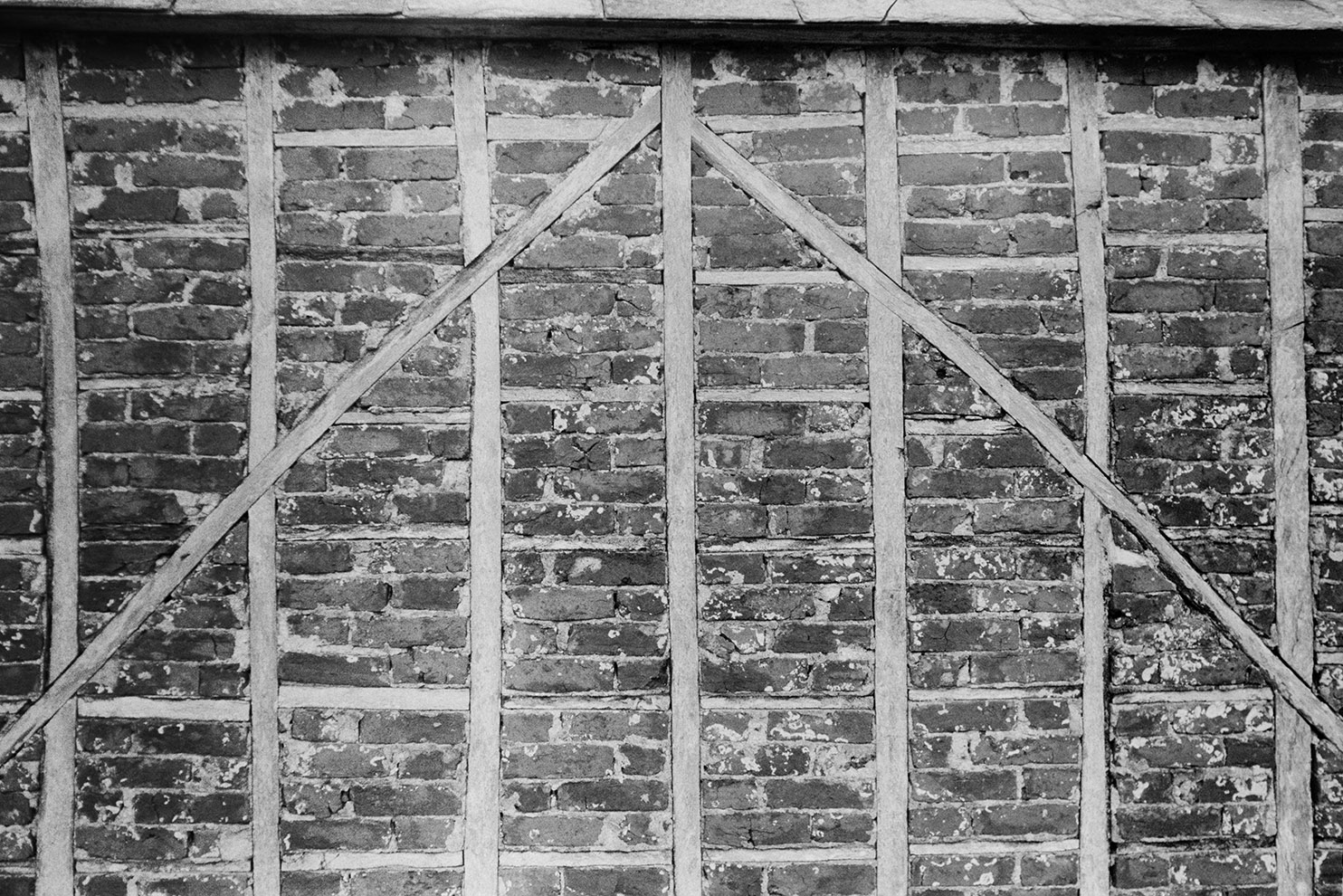 A close up view of a wall with a brick and timber construction, at Arlington.