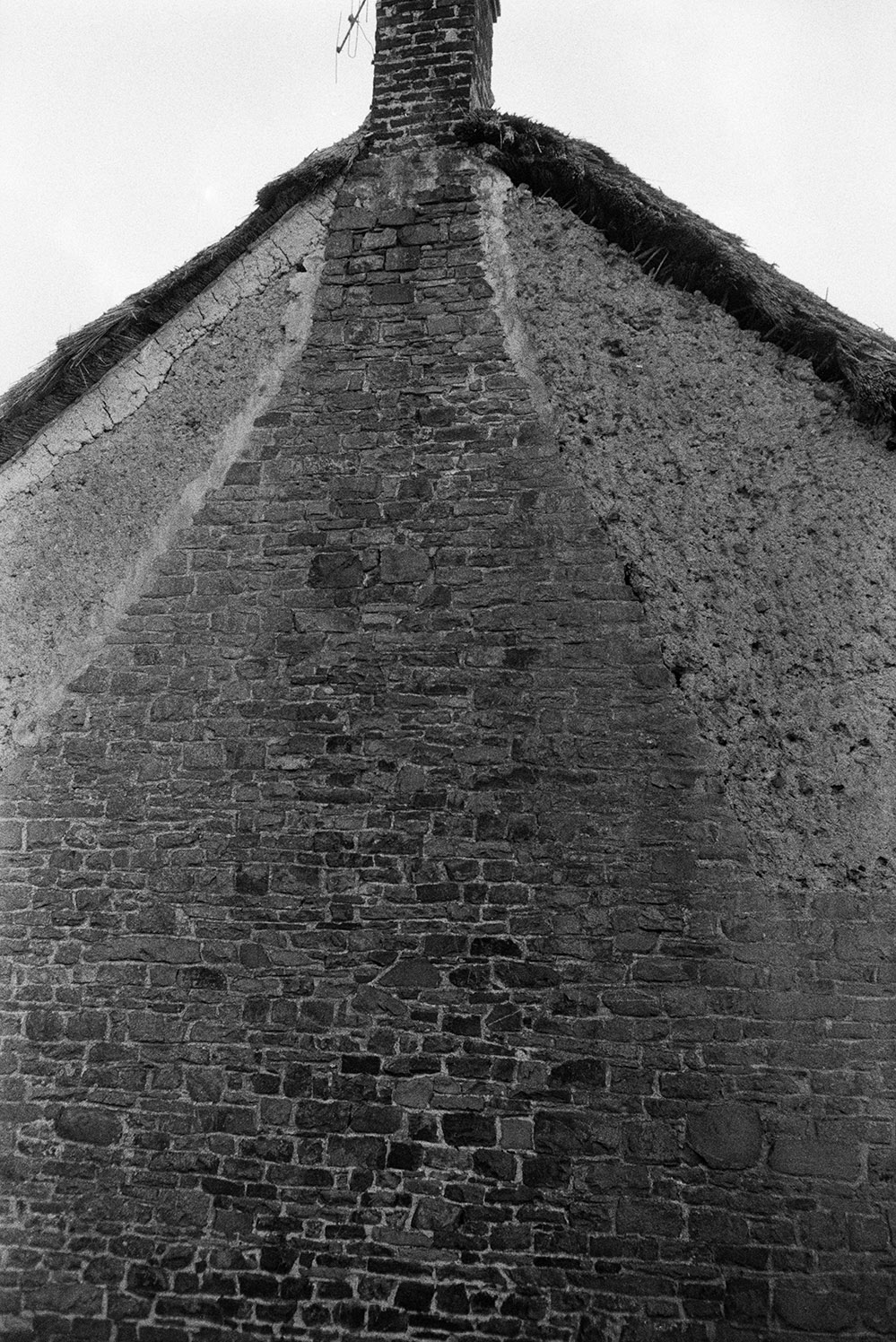 Brickwork of a chimney flue on the exterior of a house in Atherington. The flue I surrounded by cob.