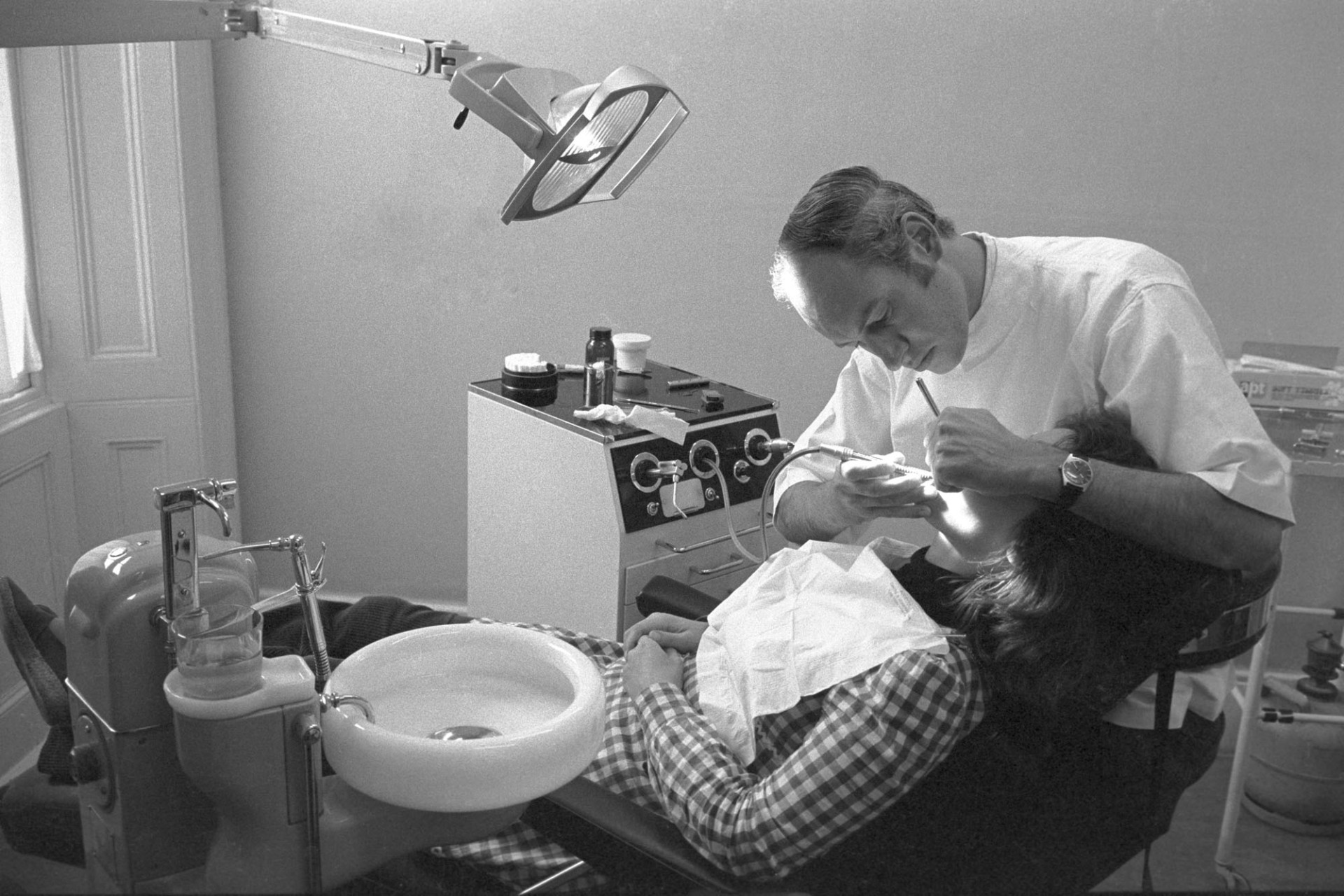 Dentist and assistant treating woman (my wife!)
[Mr Rollinson, dentist, treating Robin Ravilious in his dentist surgery at Halsdon terrace, Torrington.]
