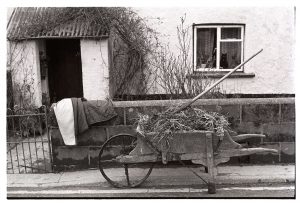 Old wheelbarrow by James Ravilious