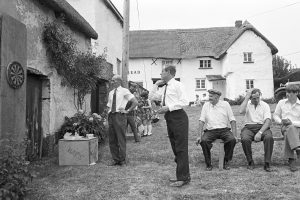 Playing darts at Iddesleigh Church Fete by James Ravilious