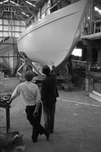 Director of boatyard looking at a new yacht by James Ravilious