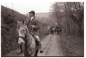 Hunt Master calling the hounds by James Ravilious