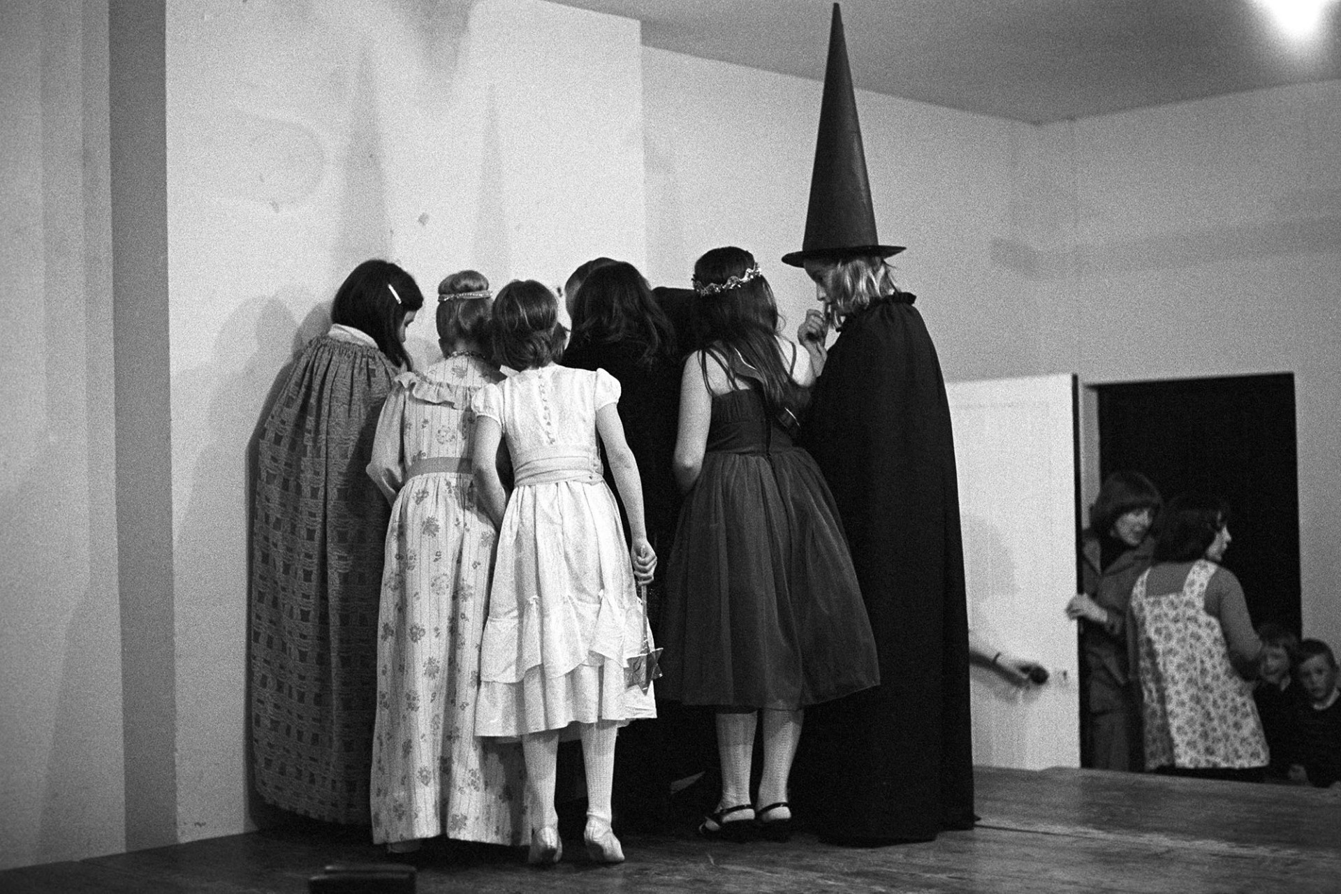 Children performing at school concert.
[Children performing at St Giles in the Wood School concert. One of the children is dressed as a witch.]