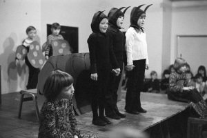 Children performing in school concert by James Ravilious
