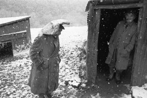 Archie Parkhouse and Ivor Brock sheltering from the snow by James Ravilious