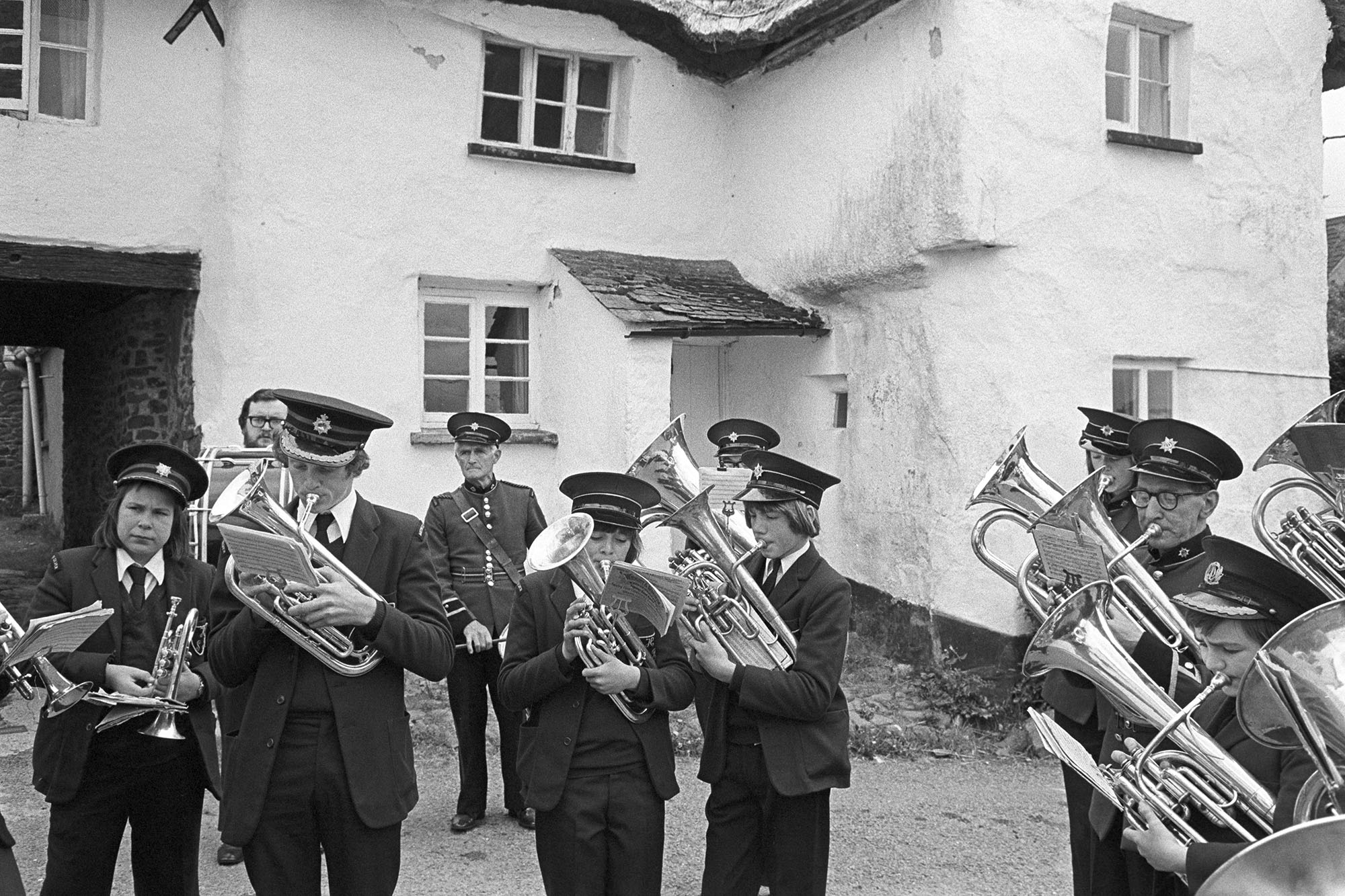 Hatherleigh Silver Band playing outside the Duke of York pub by James Ravilious