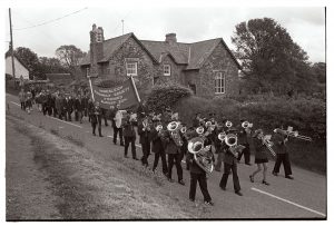Hatherleigh Silver Band leading the Club Day procession by James Ravilious