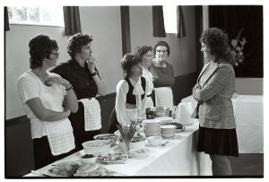 Catering staff at wedding reception by James Ravilious