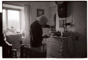 Mrs Piper making tea by James Ravilious