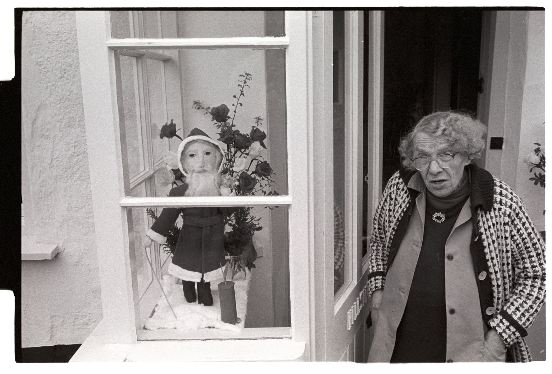 Woman with Father Christmas she had made.<br />
[Emily Easterbrook stood in the doorway of her porch, next to a display of her home made Santa Clause doll and flower arrangement, in West Lane, Dolton.]
