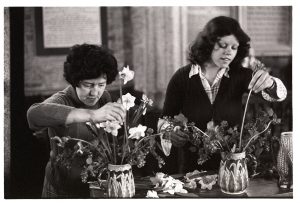 Women arranging Easter flowers by James Ravilious