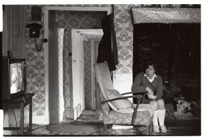 Girl watching television after school by James Ravilious