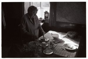 Mrs Hatherley cutting ham for lunch by James Ravilious