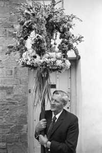 Cecil Denford with the Hatherleigh Church Sunday School garland by James Ravilious