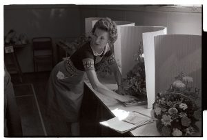 Woman judging flowers at the Conservative Flower Show by James Ravilious