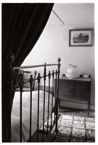 Bedroom interior with washstand by James Ravilious