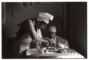 Doctor Paul Bangay carving turkey for a patient