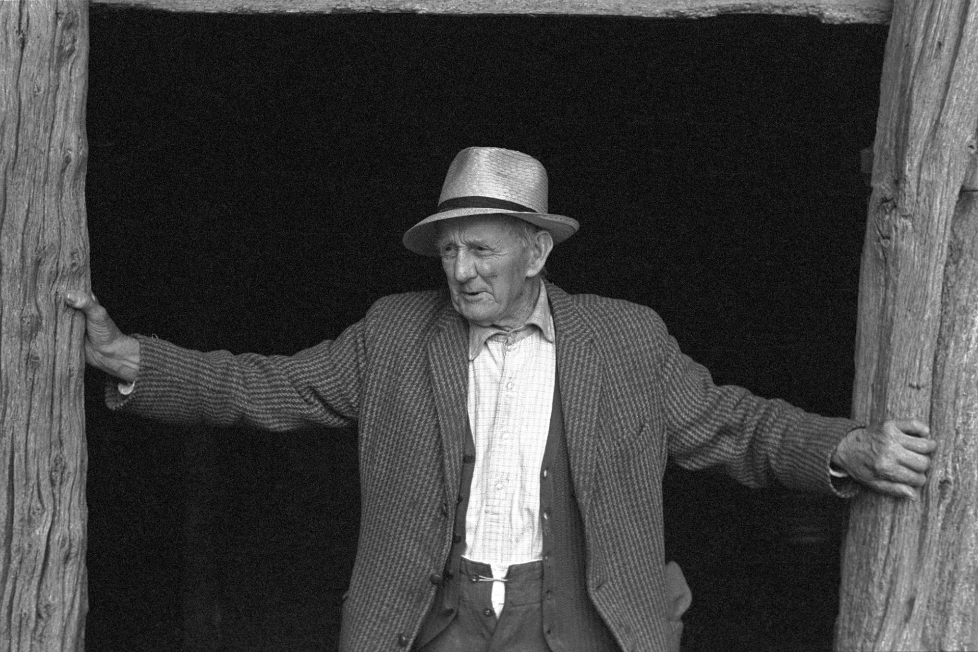 Man in straw hat at doorway of barn.
[Amos Oke standing in a doorway at Deckport Farm, Hatherleigh]