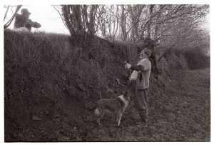 Archie Parkhouse and Alf Pugsley chatting over a hedge by James Ravilious