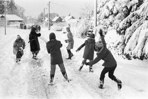 Children throwing snowballs by James Ravilious