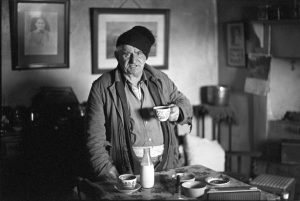Archie Parkhouse having a cup of tea after coming in from the snow by James Ravilious