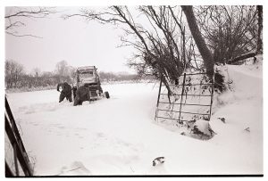 Alf Pugsley and Phillip George digging out a tractor by James Ravilious