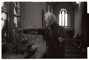 Eve Lynch-Blosse arranging flowers for Easter by James Ravilious