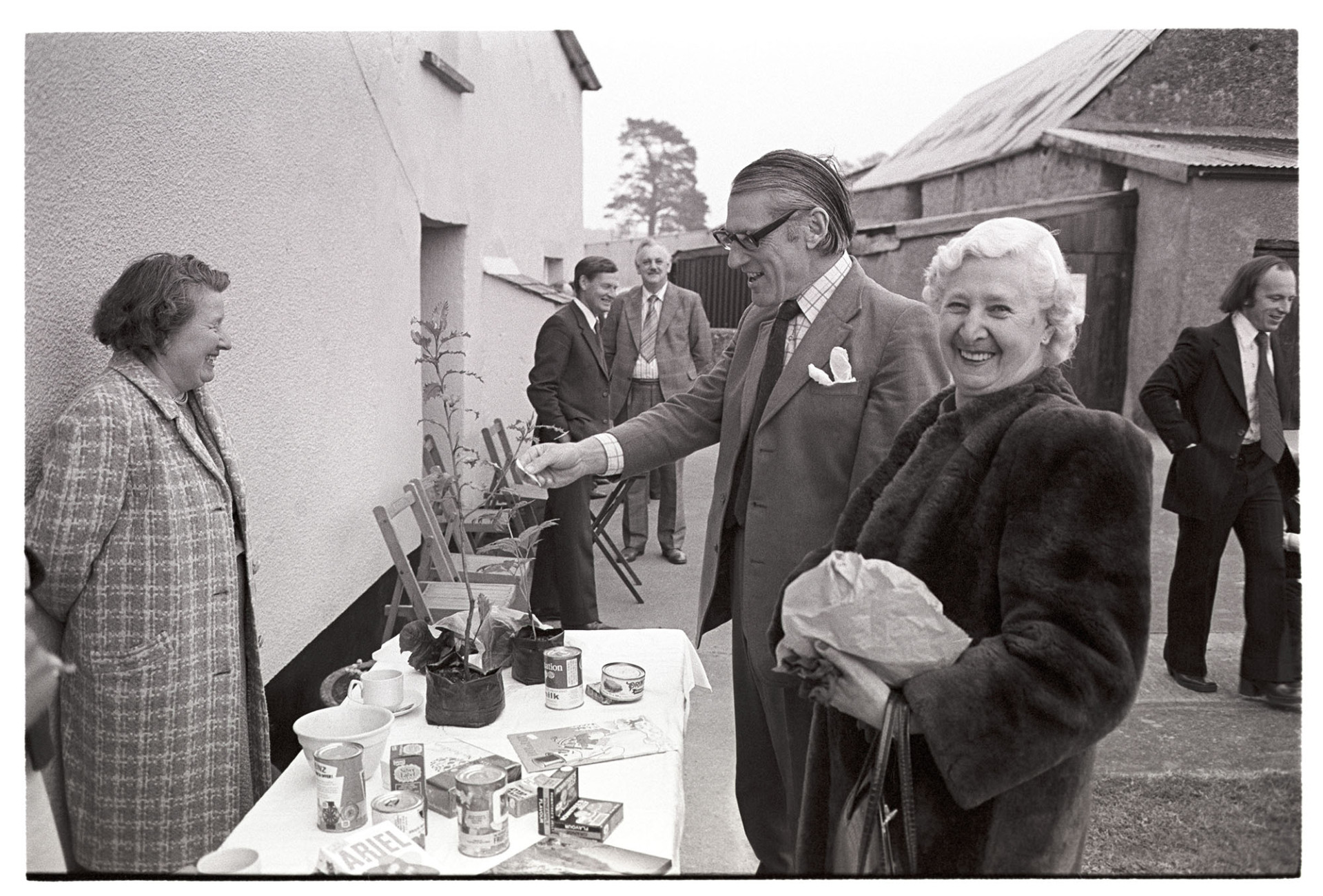 Conservative Party fete at farm, MP and woman at produce stall. 
[Peter Mills MP and a woman looking at a plant on a stall at the Conservative Party Fete at great Cudworthy Farm, Dolton.]