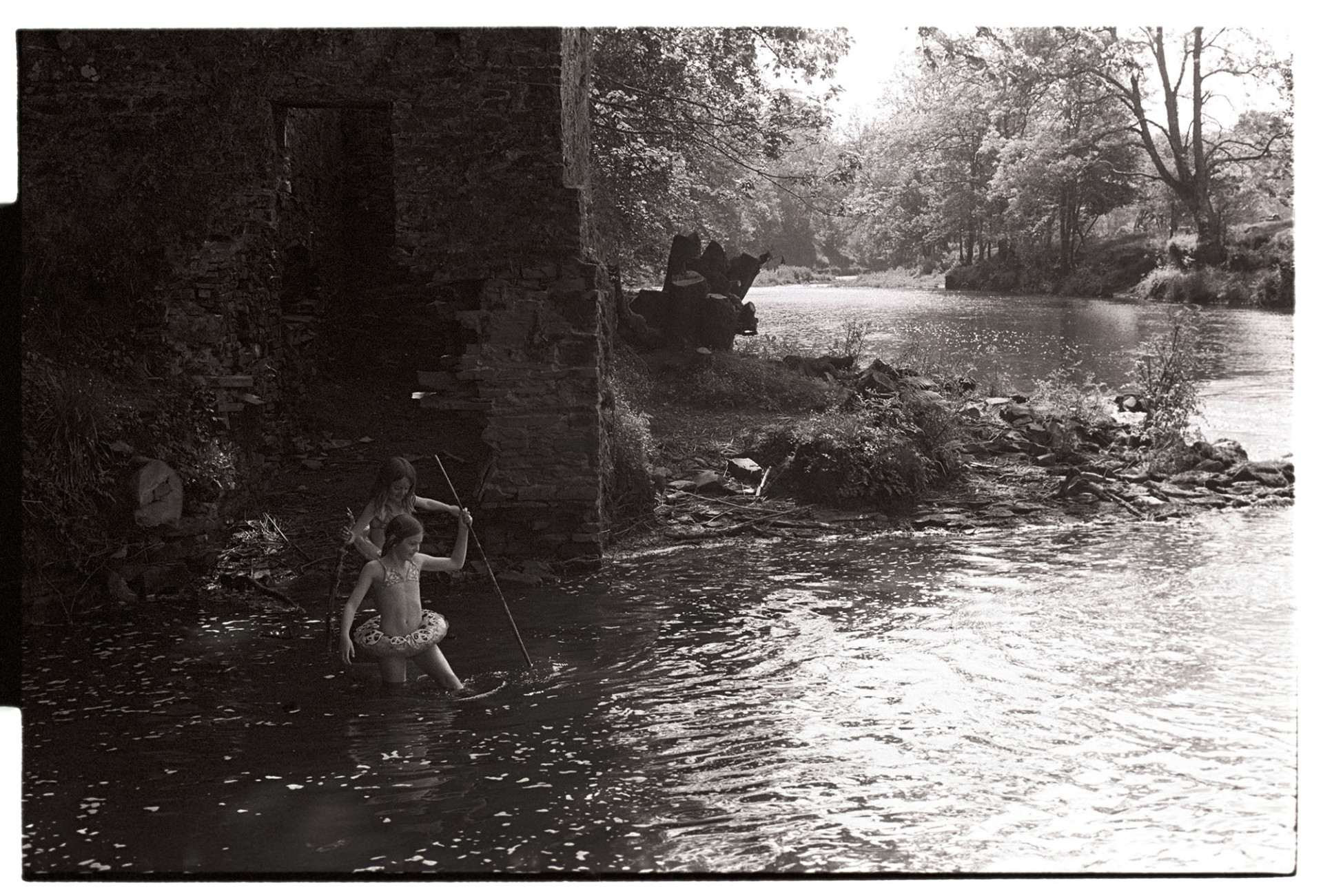 Children swimming beside Dolton Mill by James Ravilious