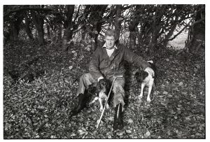 Beater with dogs by James Ravilious