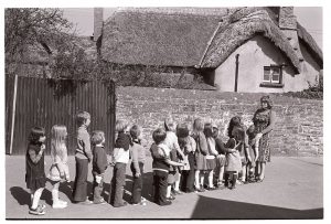 Children lined up in the school yard by James Ravilious