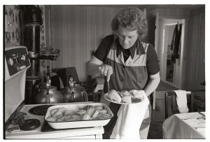 Marion Middleton preparing lunch for reedcombers by James Ravilious