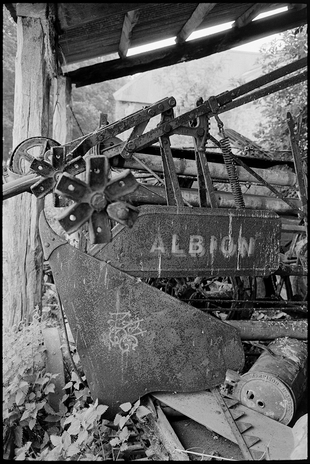 Reap and binder in shed. 
[An Albion Reap and Binder in an open barn at Densham, Ashreigney.]