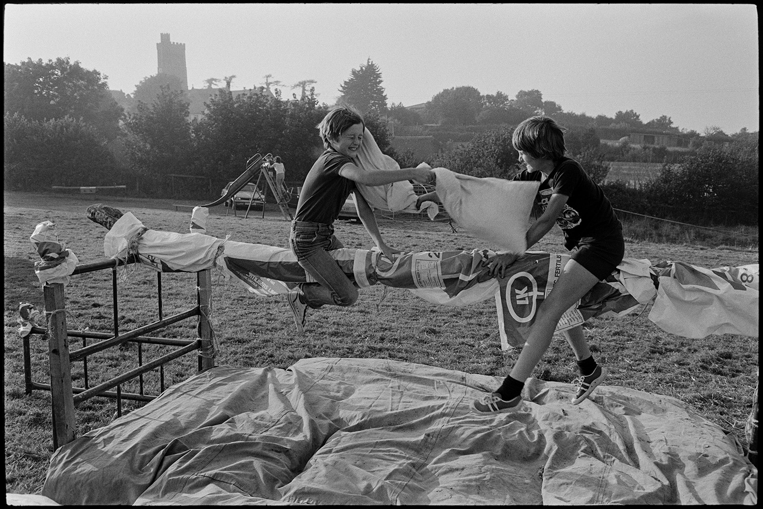 Competitors preparing, gymkhana organisers marquee. 
[Two boys having a pillow fight on a greasy pole at Beaford Gymkhana.]