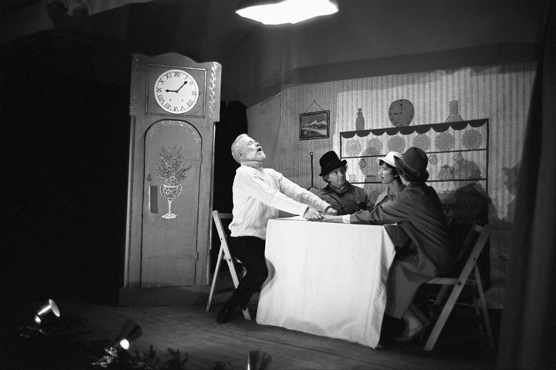 Christmas entertainment in village hall, scene from play, Actor in clock !! <br />
[The Women's Institute Christmas play in High Bickington village hall. An actor is hiding in the clock. The performers from left to right are Mr Harpum, Chris England and Glenda Tucker.]